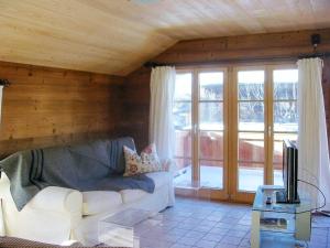 a living room with a white couch and a tv at Mountain House With Sauna In Sachrang in Sachrang