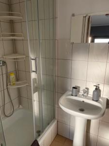 a bathroom with a sink and a shower at Pokój u Patki in Rowy +9 photos