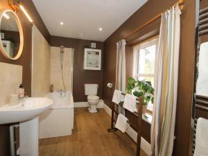 a bathroom with a sink and a toilet and a mirror at Little Pentwyn in Hereford +17 photos