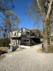 a house on a hill with a tree at WaldQuartier in Memmelsdorf