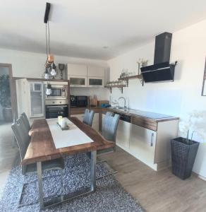 a kitchen with a wooden table and a dining room at Apartmani Lea in Bribir