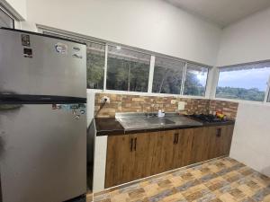a kitchen with a stainless steel refrigerator and a sink at Aguakey in Tauramena