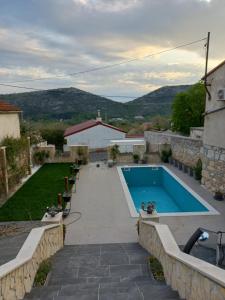 a swimming pool in the backyard of a house at Apartmani Lea in Bribir
