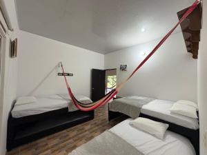 a room with two beds and a hammock in it at Aguakey in Tauramena