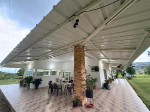 a patio with a table and chairs under awning at Aguakey in Tauramena