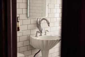 a bathroom with a sink and a mirror at The Wilson in Madison