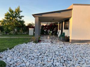 a large pile of rocks in front of a house at F2 Farmhouse in Omuthiya