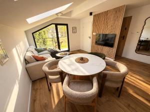 a living room with a table and a couch at Vistula Apartment in Ustroń