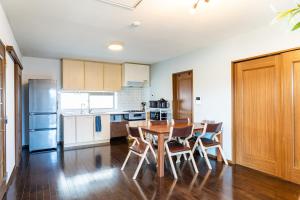 a kitchen with a table and chairs in a room at Ninja Village - Miyajima in Hatsukaichi