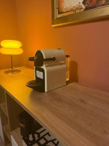 a toaster sitting on a table next to a lamp at Appart G2 in Abidjan