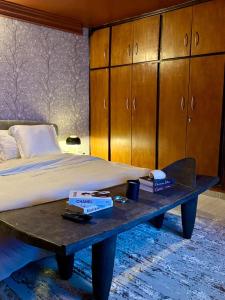 a bedroom with a bed and a wooden cabinet at Appart G2 in Abidjan