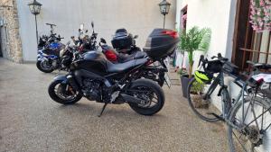 a row of motorcycles parked next to a building at Pansion Oscar Summer Garden in Mostar