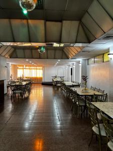 a large room with tables and chairs in a room at Hotel Los Andes Inn in Guayaquil