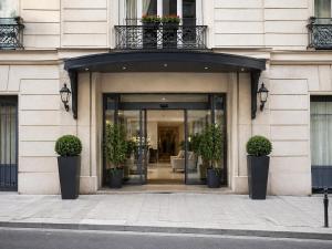 an entrance to a building with potted plants on it at Casa Velvet in Madrid