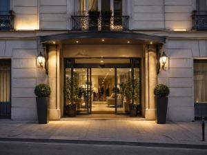 an entrance to a building with potted plants at Casa Velvet in Madrid +1 photo
