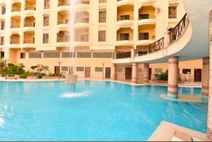 a large swimming pool in front of a building at Green View Compound Apartment in Alexandria
