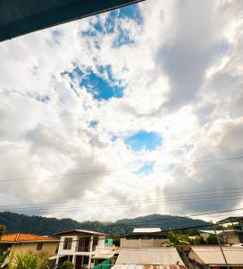 a view of a cloudy sky over a city at Hostal El Viajero-Mindo in Mindo