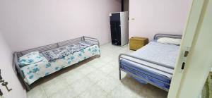 a bedroom with two beds in a room at Green View Compound Apartment in Alexandria