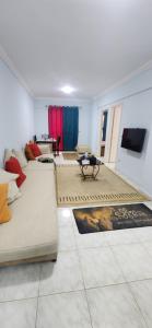 a living room with couches and rugs on the floor at Green View Compound Apartment in Alexandria