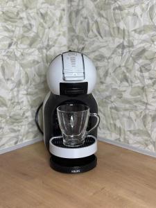 a coffee maker with a cup on top of it at Olivia -Ελιά in Paleo Tsifliki