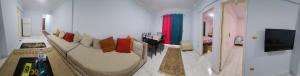 a living room with a couch and a tv at Green View Compound Apartment in Alexandria +6 photos