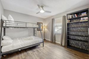 a bedroom with a bunk bed and a book shelf at Relaxed Poolside Gym Escape in Green Cove Springs +47 photos