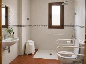 a bathroom with a toilet and a sink at L'Albea Hotel Rural in Vall dʼAlba +18 photos