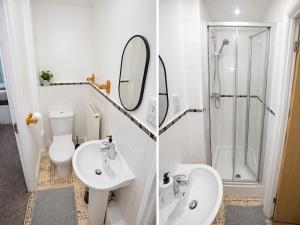 a bathroom with a sink and a toilet and a shower at Greenhithe Guest House in Stonewood +15 photos