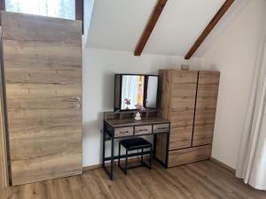 a room with a desk with a mirror and a door at Chalet Wörthersee in Velden am Wörthersee