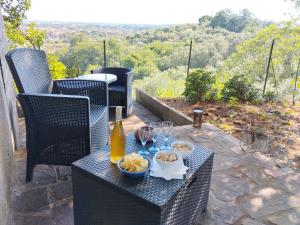 a table with a bottle of wine and bowls of food at Da Poldino in Borgo a Buggiano