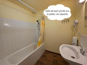 a bathroom with a sink and a tub and a sink and a toilet at Hostel du Canyon in La Palud-sur-Verdon
