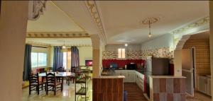 a kitchen and dining room with a table and chairs at Villa Galactik Pegasus in Tamraght Ou Fella