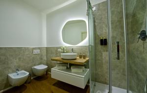 a bathroom with a sink and a toilet and a shower at NS Urban Suite in Udine