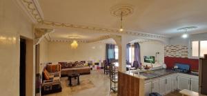 a living room with a couch and a table at Villa Galactik Pegasus in Tamraght Ou Fella