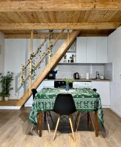 a kitchen with a table with a green blanket on it at Cozy cottage in Biisi in Biisi