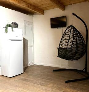 a room with a white refrigerator and a tv at Cozy cottage in Biisi in Biisi