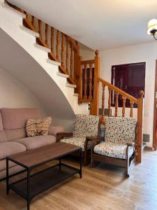 a living room with a couch and two chairs at Casa rural en La Adrada con jardín in La Adrada