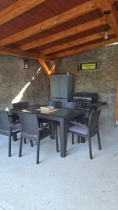 a table with chairs and a grill in a patio at Jelena in Jajce