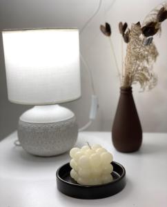 a bowl of marshmallow on a table next to a vase at Cozy cottage in Biisi in Biisi +5 photos