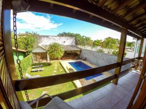 a view from a window of a house with a swimming pool at Casarão do Coronel - Descanso e lazer em Maresias na Praia do Saco in Maresias