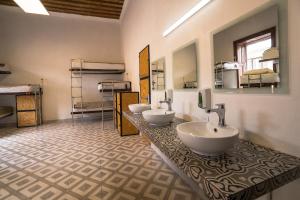 a bathroom with two sinks and two bunk beds at Casona Poblana Hotel Puebla in Puebla +53 photos