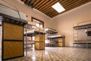 a room with three bunk beds in a building at Casona Poblana Hotel Puebla in Puebla