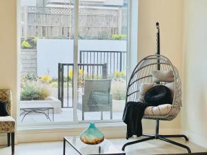 a room with a rattan chair in a living room at Family Friendly Ground Level Condo in Surrey