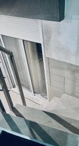 an empty room with two windows and a staircase at Billis Cologne Apartment in Flogita