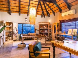 a living room with a table and some chairs at Avenir Safari Group in Okahandja