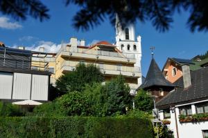 a building with a clock tower and a church at Appartement 4You in Schladming