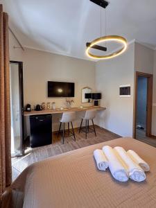a bedroom with a bed with two white towels at Gregory Central Apartment in Chania