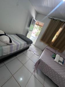 a bedroom with a bed and a table in it at Pousada são Martins in Estivado