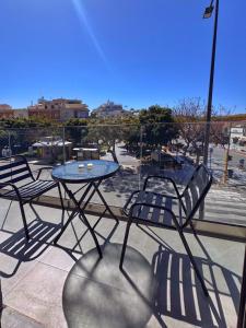 a table and chairs sitting on a patio at Gregory Central Apartment in Chania
