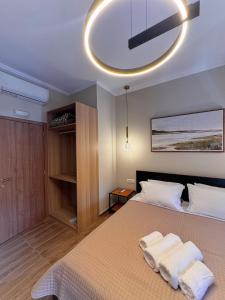 a bedroom with a bed with two towels on it at Gregory Central Apartment in Chania
